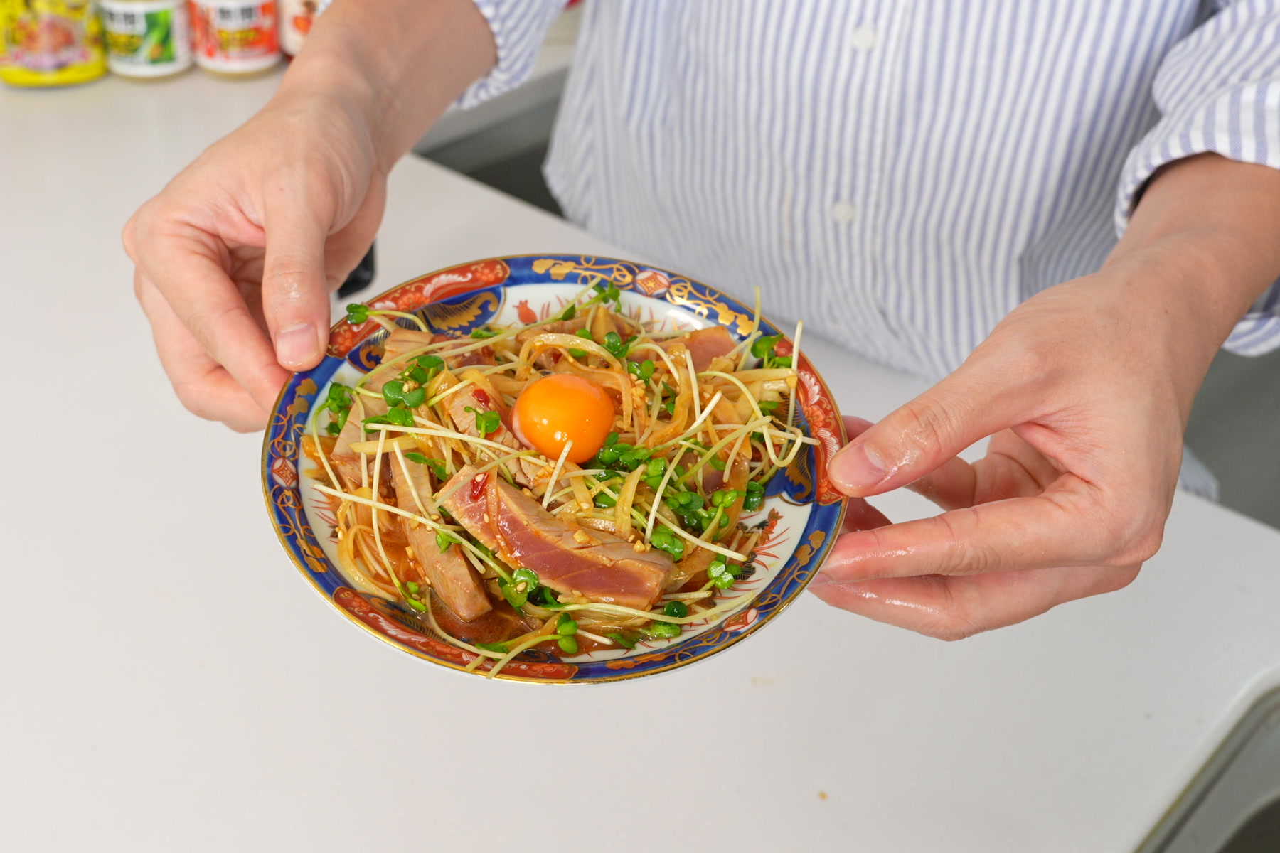 炙ったマグロに玉ねぎとカイワレを合わせ、卵黄をのせた一皿